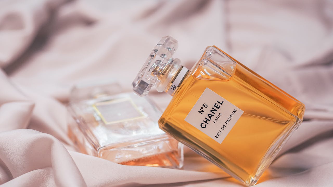 Crafting Captivating Headlines: Your awesome post title goes here Close-up of Chanel No. 5 perfume bottles elegantly placed on soft pink fabric.