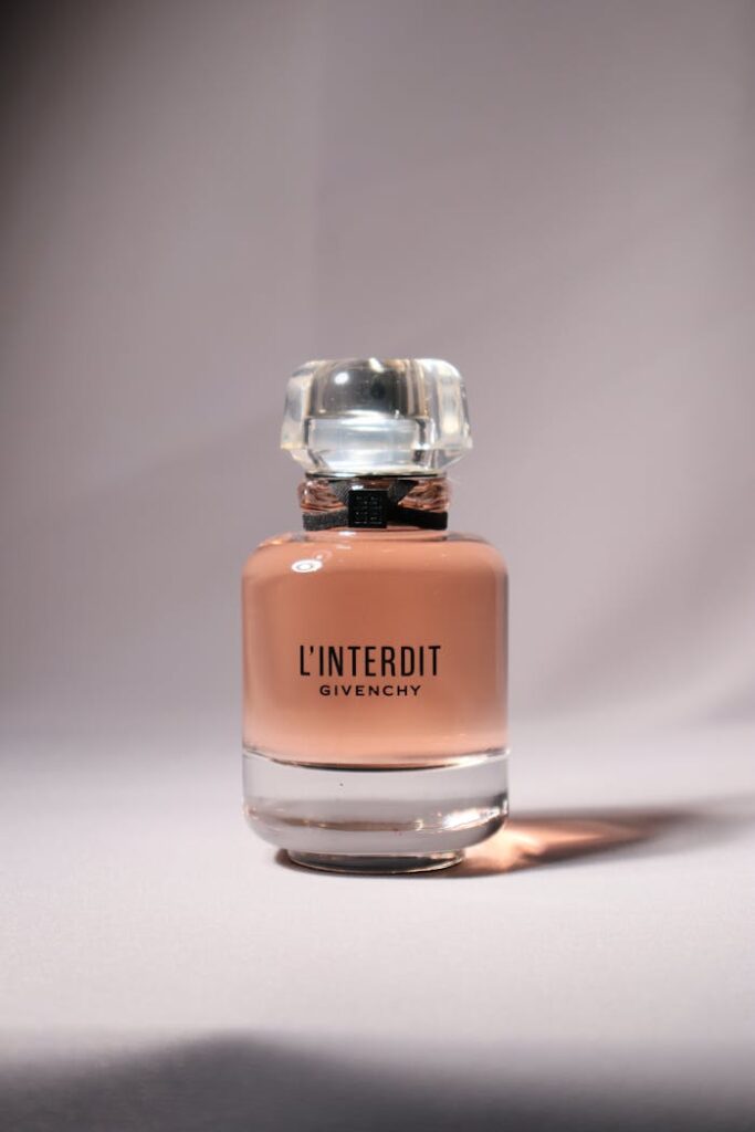 Elegant close-up of a Givenchy L'Interdit perfume bottle on a soft background.
